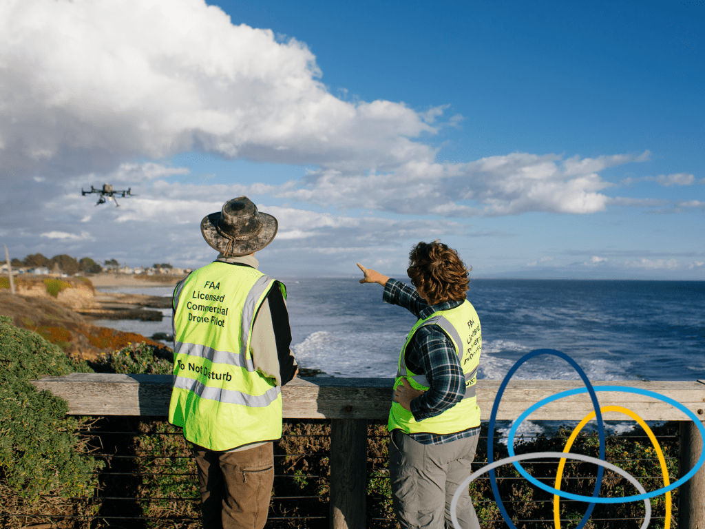 Two drone operators flying a drone over the UC Santa Cruz coastal campus to survey the landscape.